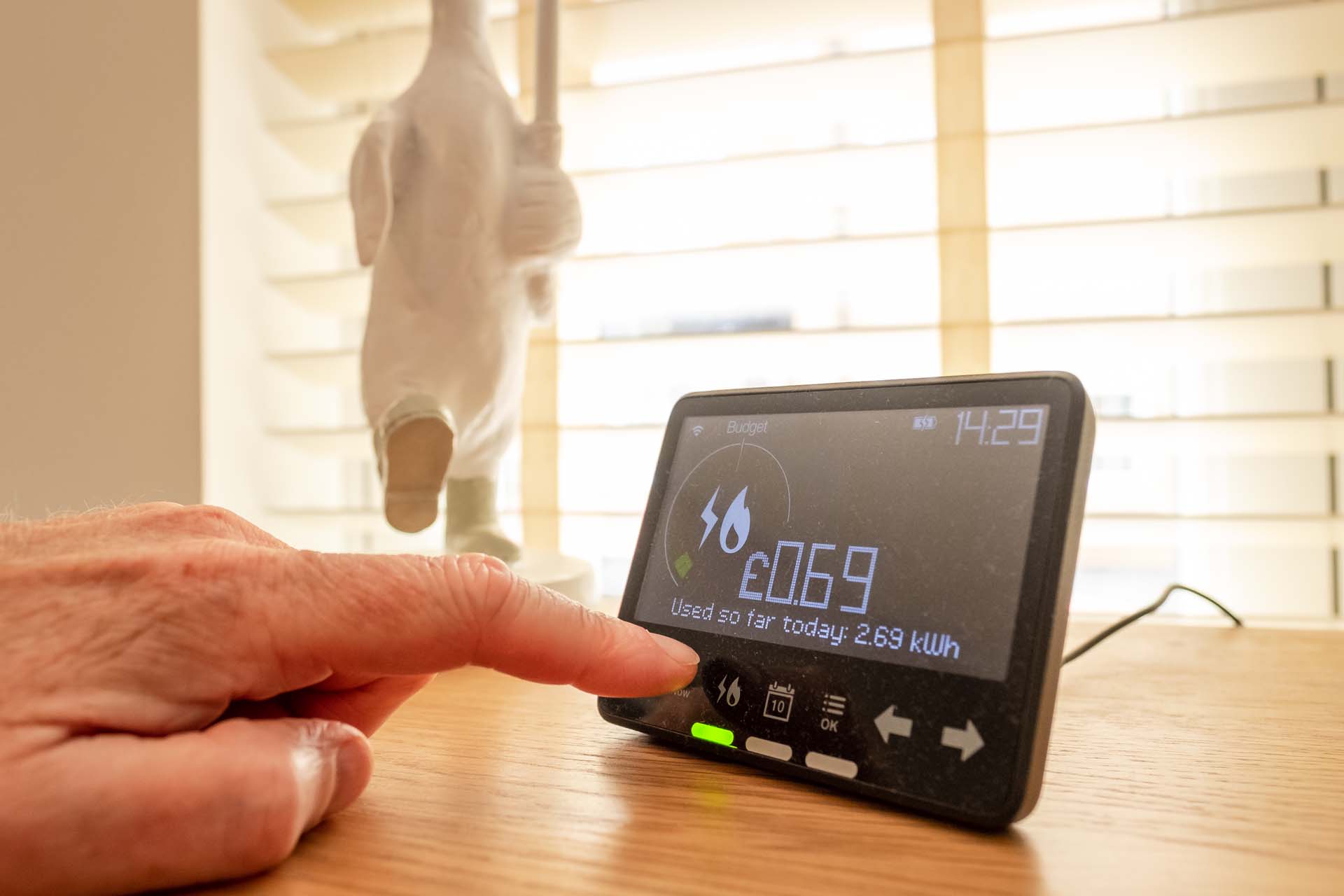 Hand pressing screen of a smart meter