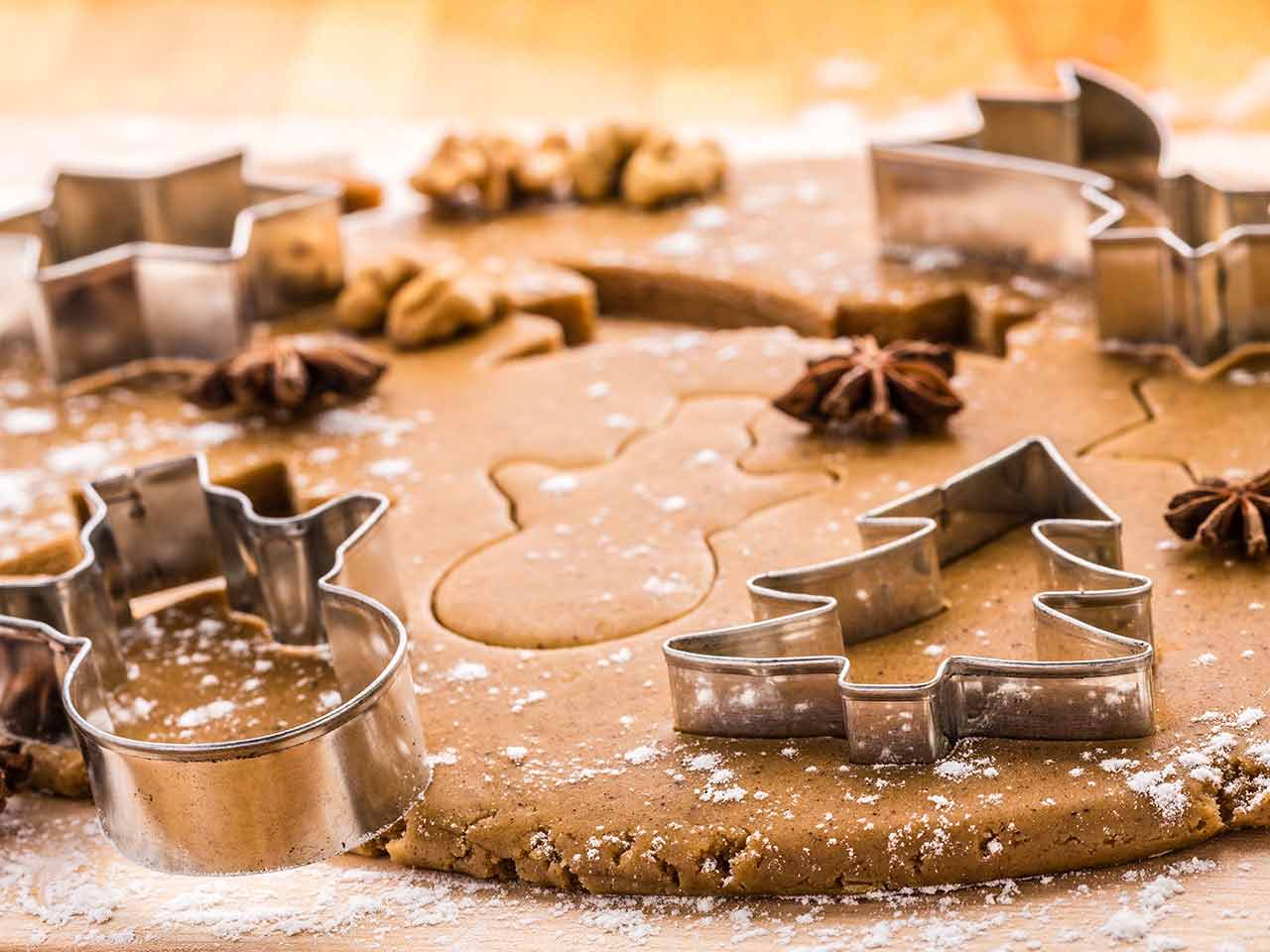 Cinnamon biscuit dough with christmas cookie cutters