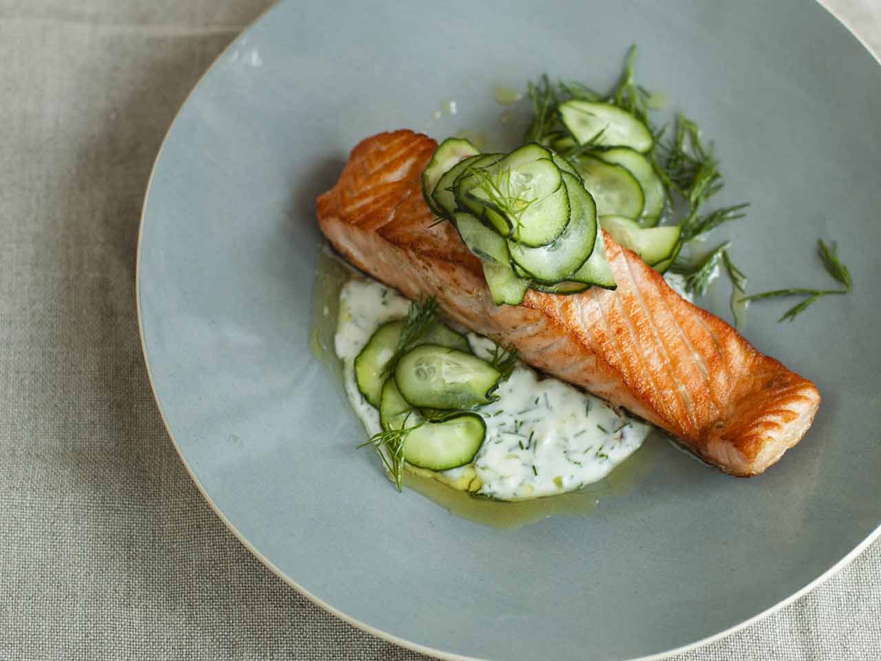 Salmon fillets with cream and dill sauce and quick pickled cucumber