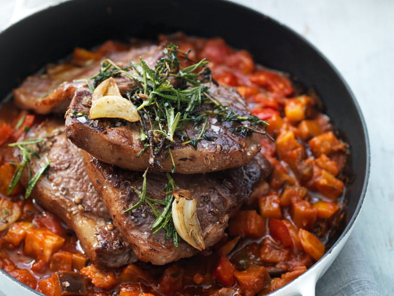 Herb-marinated lamb steaks with Mediterranean stew