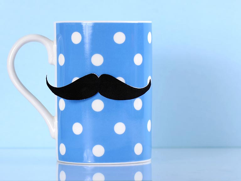 Blue and white spotty mug sporting moustache for men's health awareness