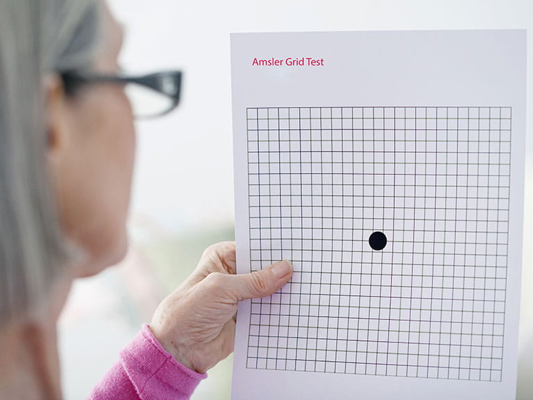 Senior woman taking AMD sight test