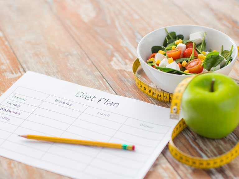 Weight loss tools, including diet diary, low calorie food and tape measure