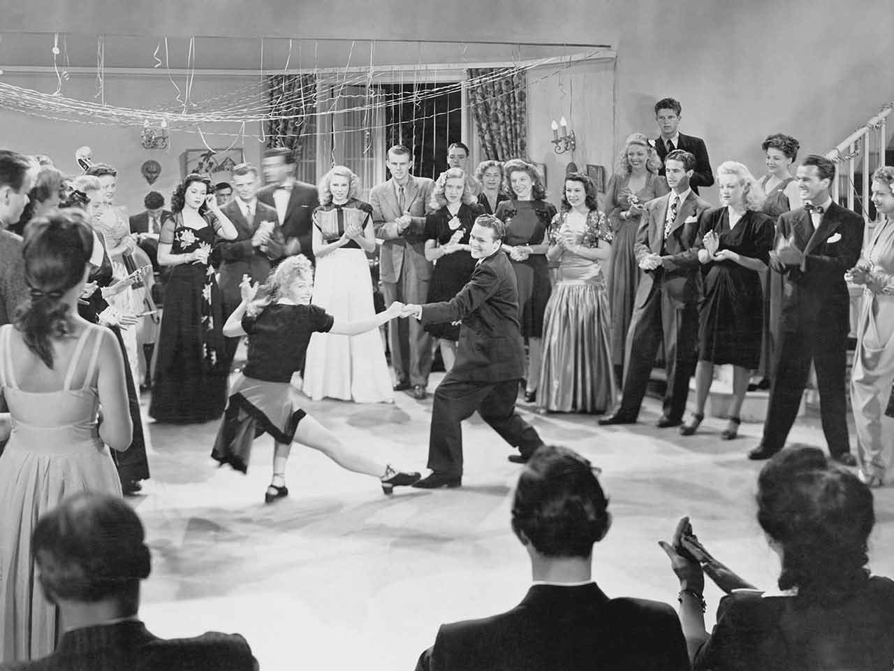 A couple swing dancing, a type of dance from the 1940s
