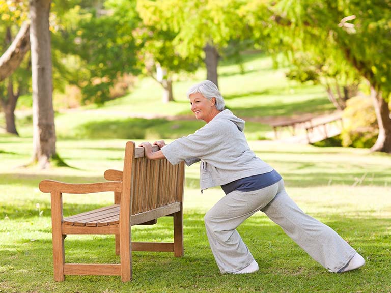 Older woman performing stretching exercises