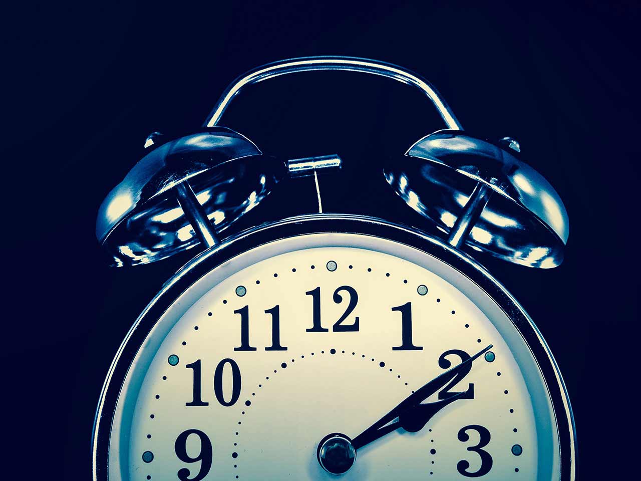 Retro alarm clock set to two o'clock symbolising insomnia