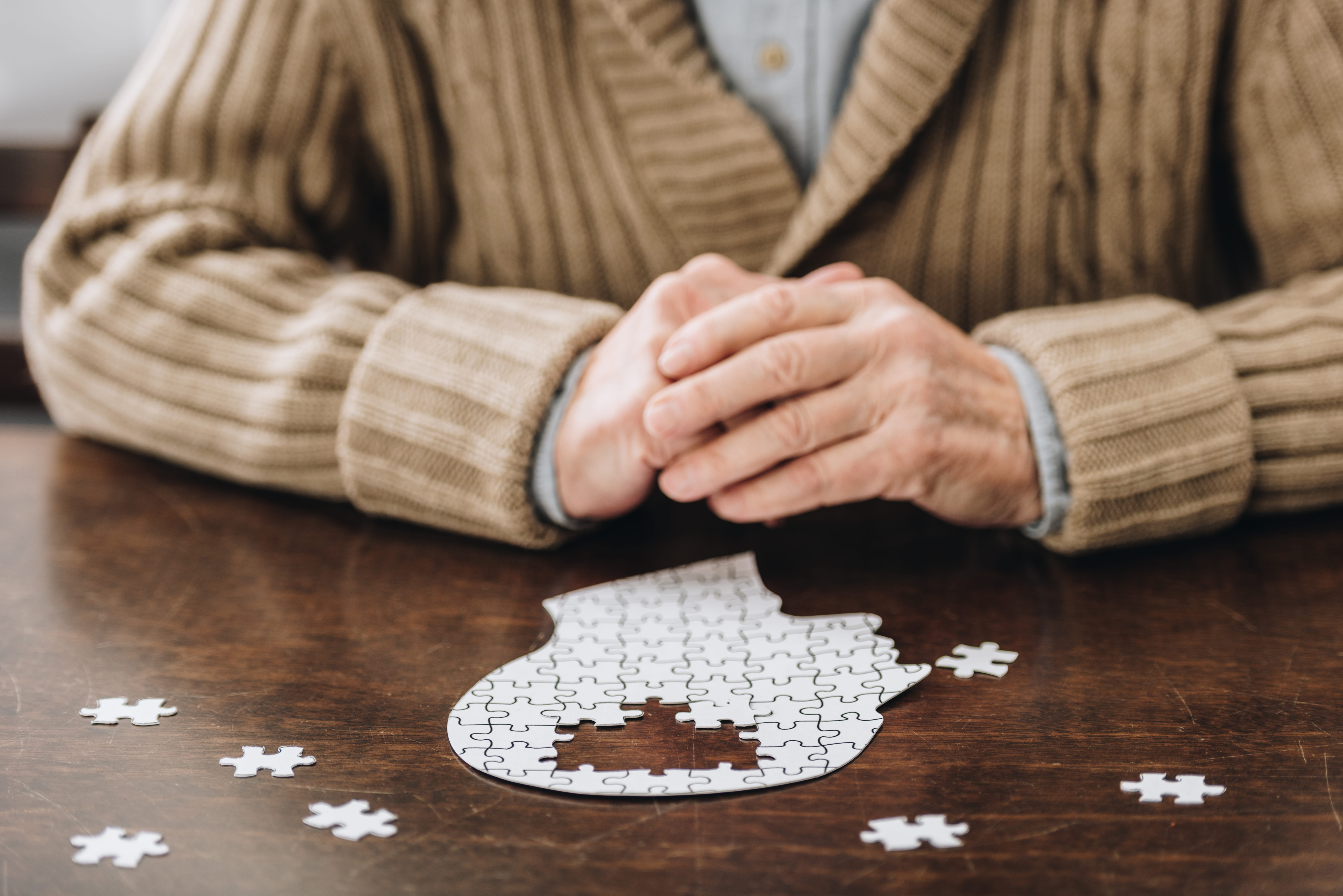 A jigsaw puzzle of a head profile with pieces missing to indicate dementia