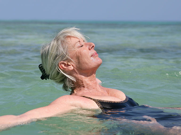 Mature woman swimming in the sea