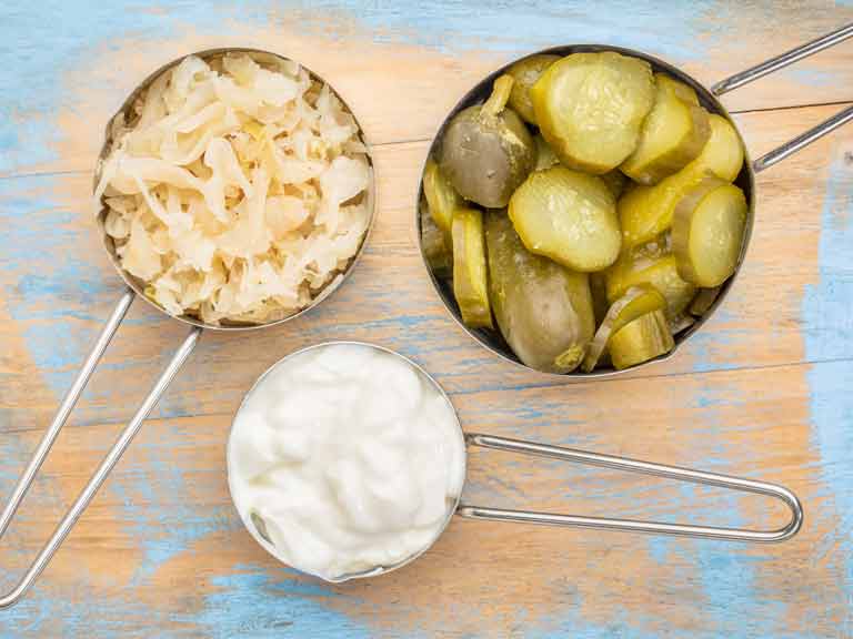 sauerkraut, cucumber pickles and yogurt - popular probiotic fermented food