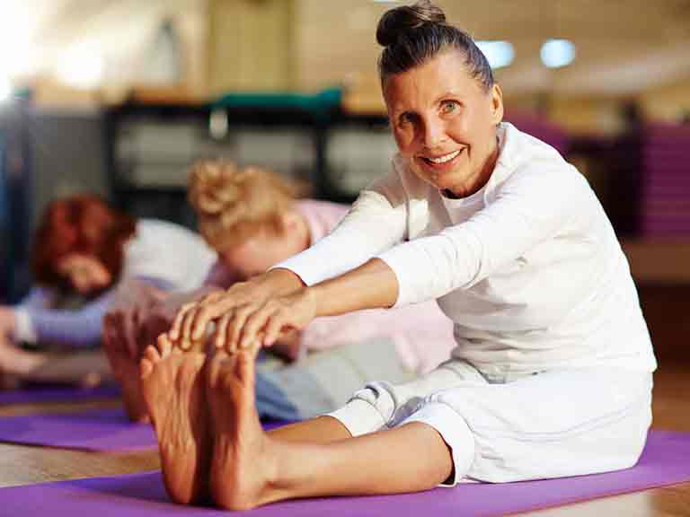 Woman stretching in yoga class