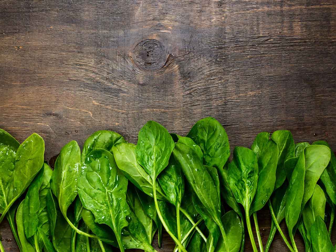 Folic acid rich spinach on a wooden board