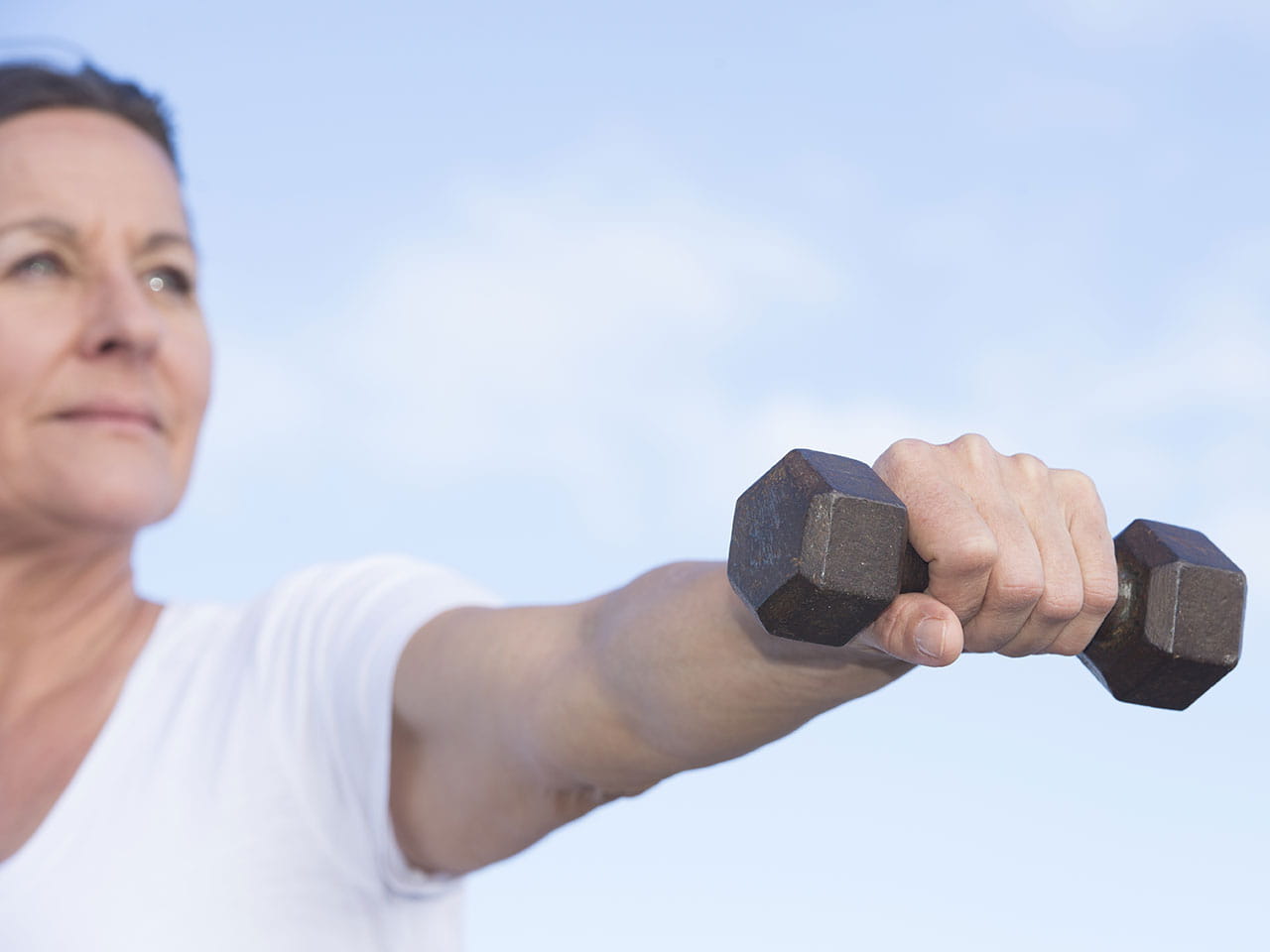 Mature woman working out with hand weights