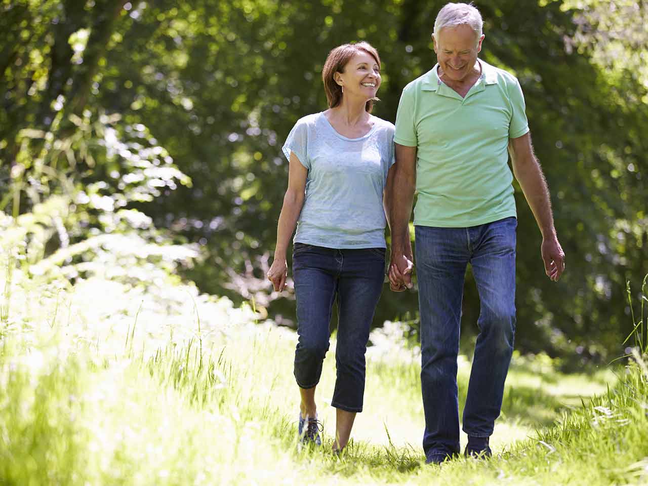 Mature couple laughing and walking in the sun