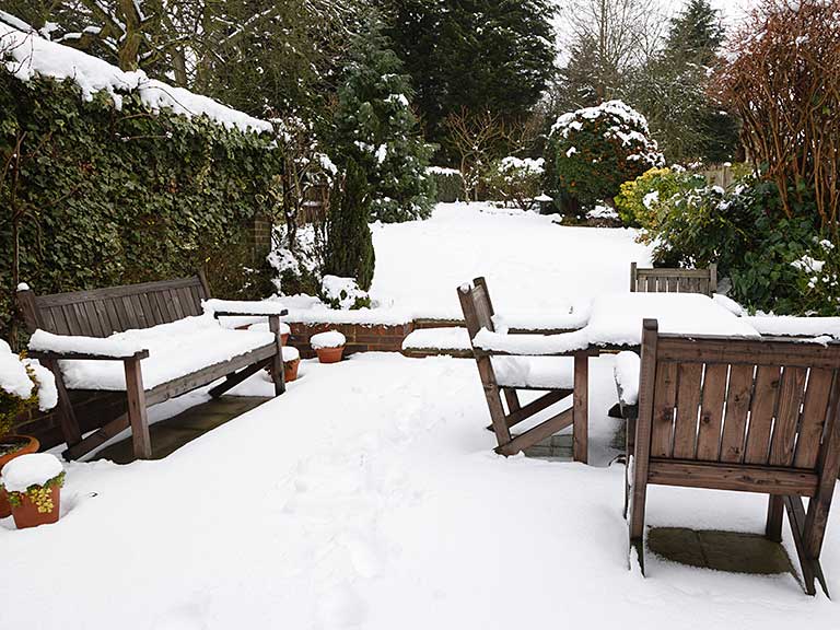 Garden furniture covered in snow
