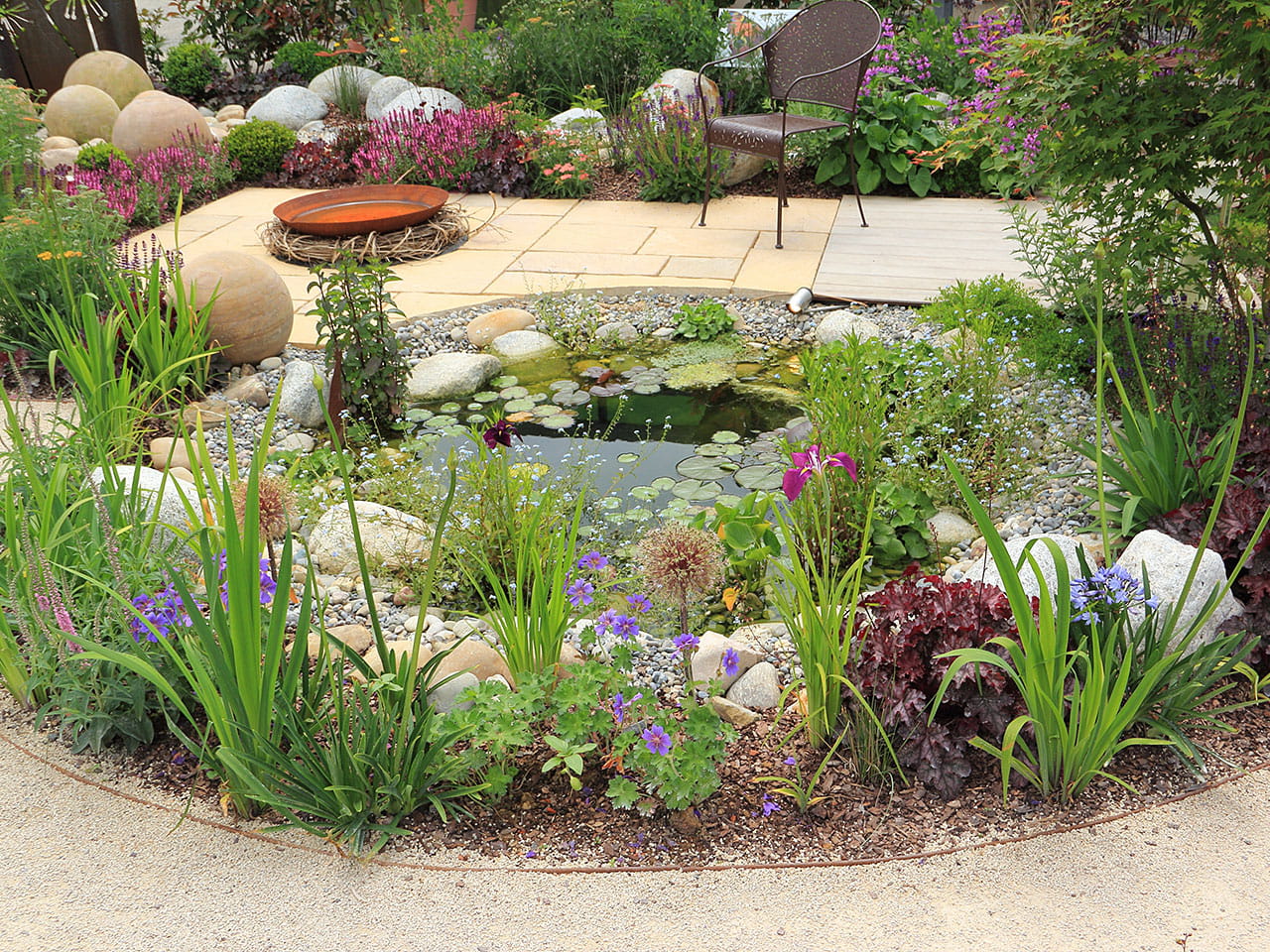 Garden pond with flowers and shrubs