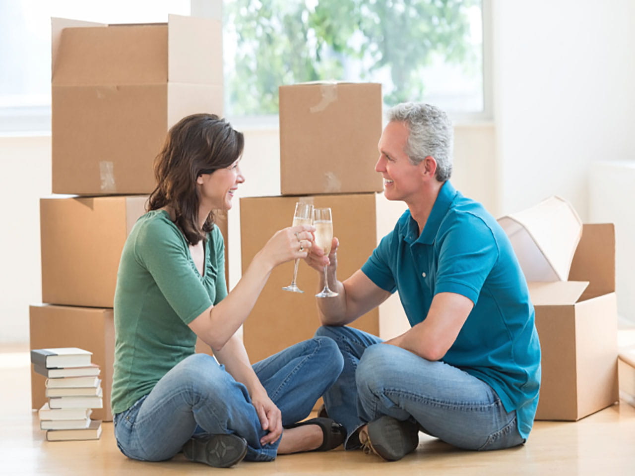 Couple sat in front of moving boxes