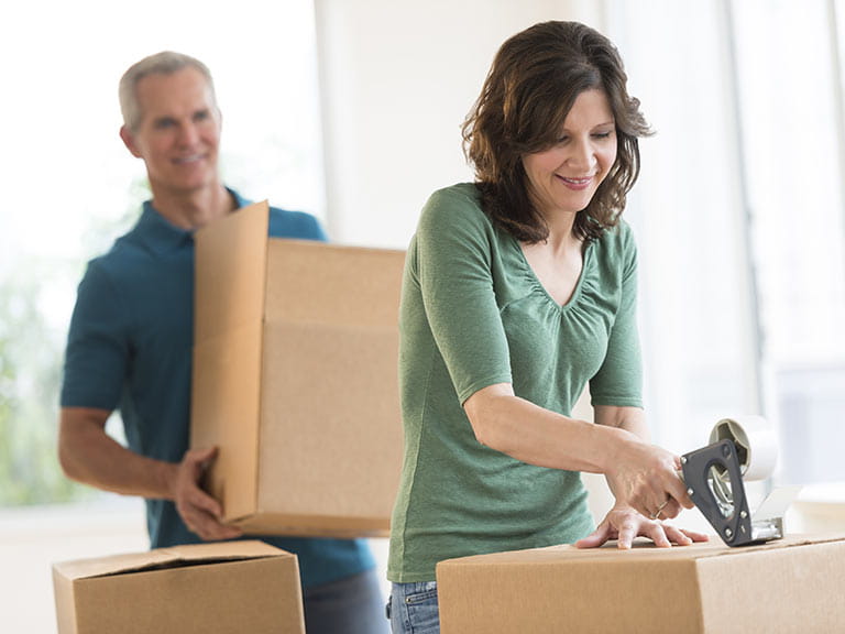 Senior couple packing to move house