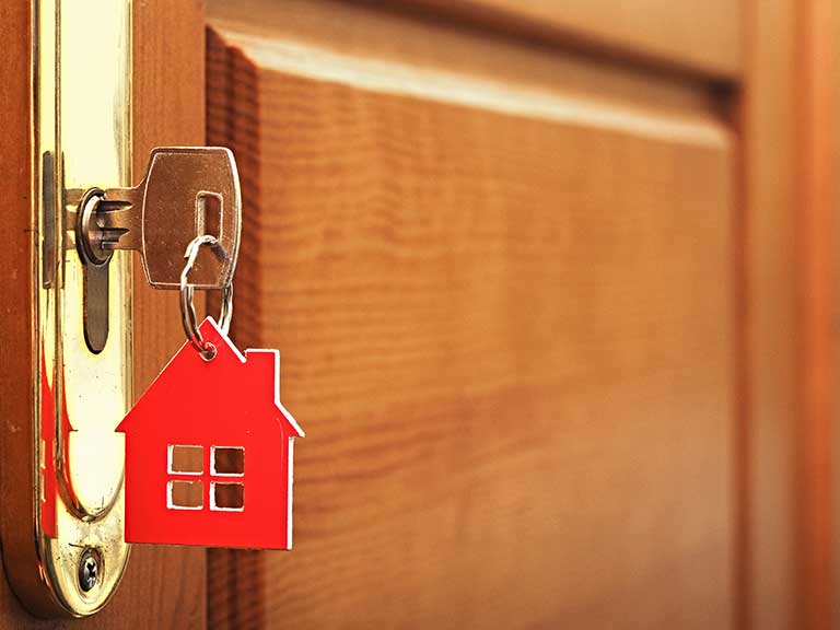 A key in a house door to represent a buy-to-let investment