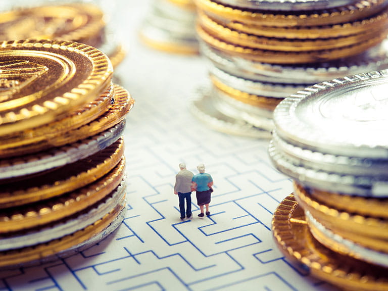 A model of an older couple navigating a maze to represent pensions