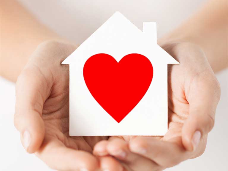 Image of a heart on a paper house to represent buying your first home.