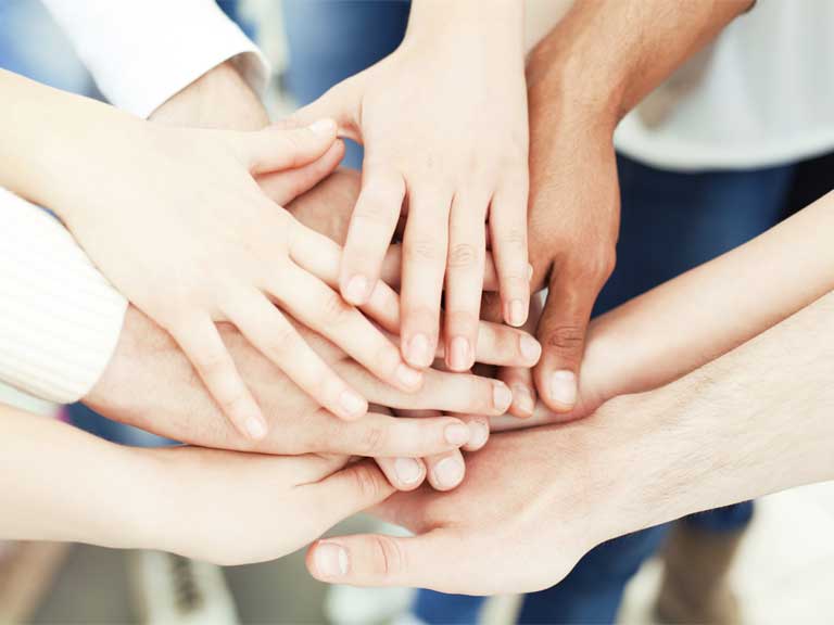Hands joined to show unity, team work and equality