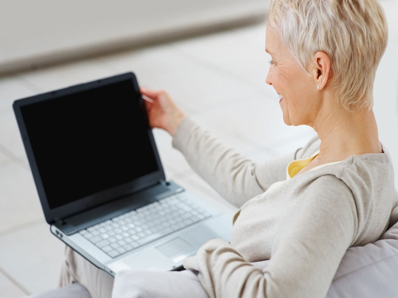 Mature woman at home on a laptop