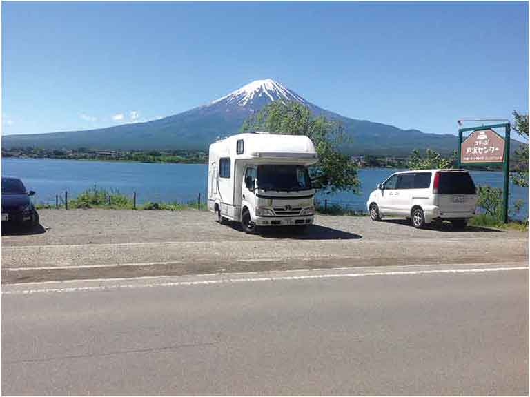 Motorhome parked by lake with view of Mount Fuji, Japan