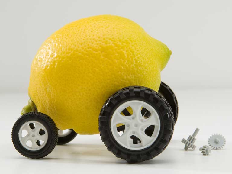 Lemon on wheels to represent buying a dodgy or shoddy car