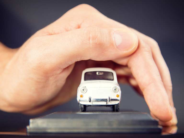 Hand shielding a classic car to protect it