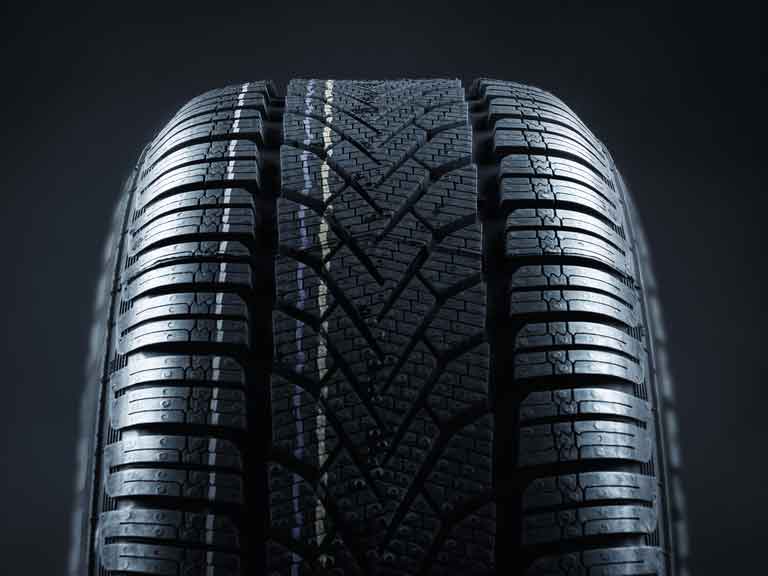 Single new car tyre showing deep tread