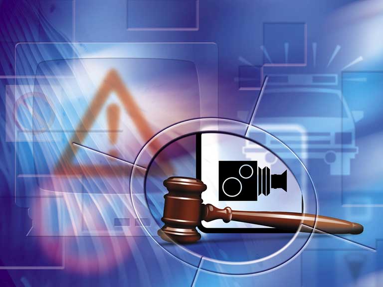 Image depicts a gavel and speed camera to represent a motoring offence