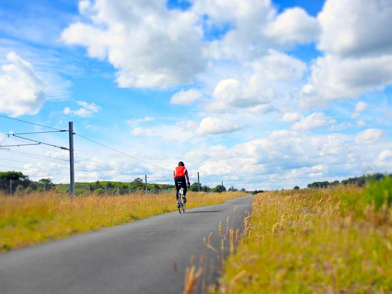 Cyclist riding along a country road.