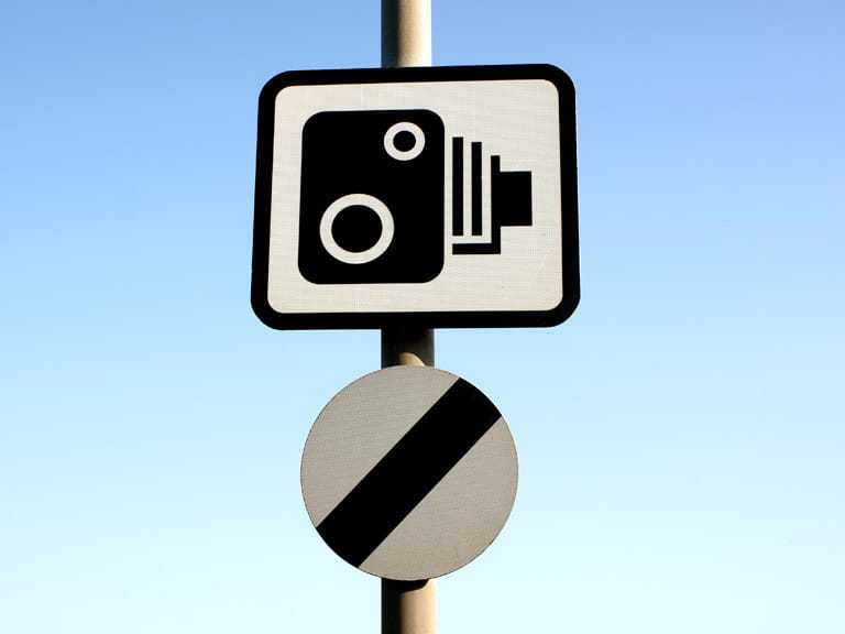 National speed limit sign and speed camera sign