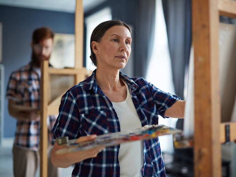 A woman taking a painting class to move on after the death of her husband