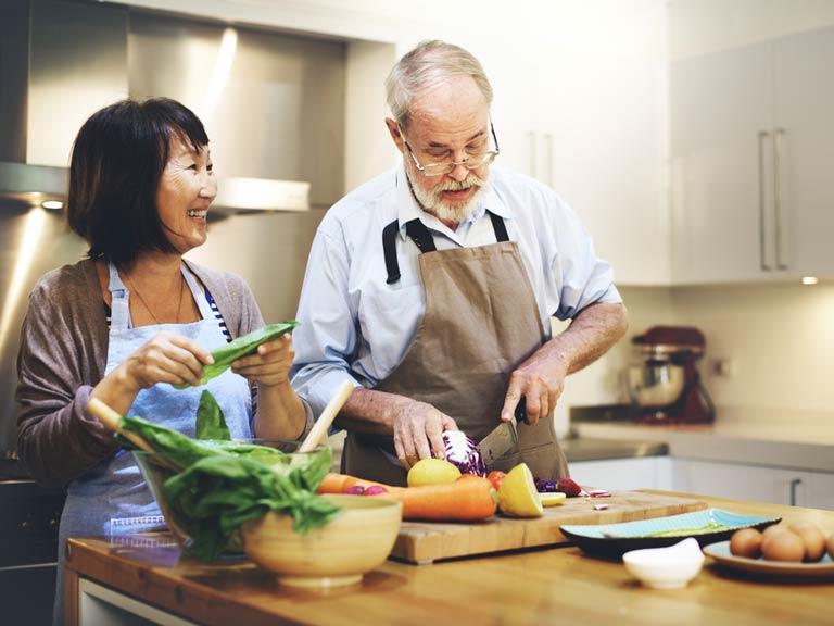 Couple laughing in kitchen