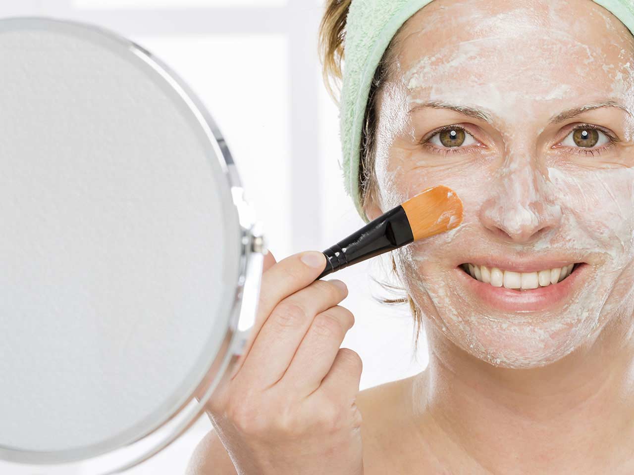 Woman using face mask for younger looking skin