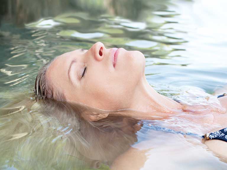 A woman relaxes in a pool