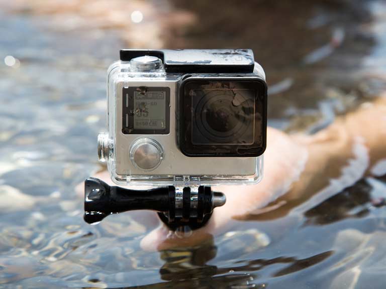 A GoPro on a tripod perches above the surface of the water