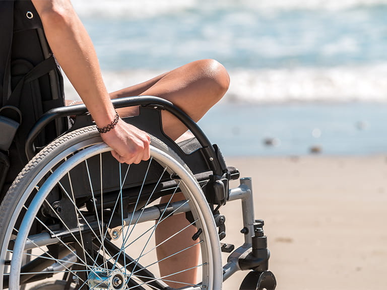 Woman in a wheelchair on a beach