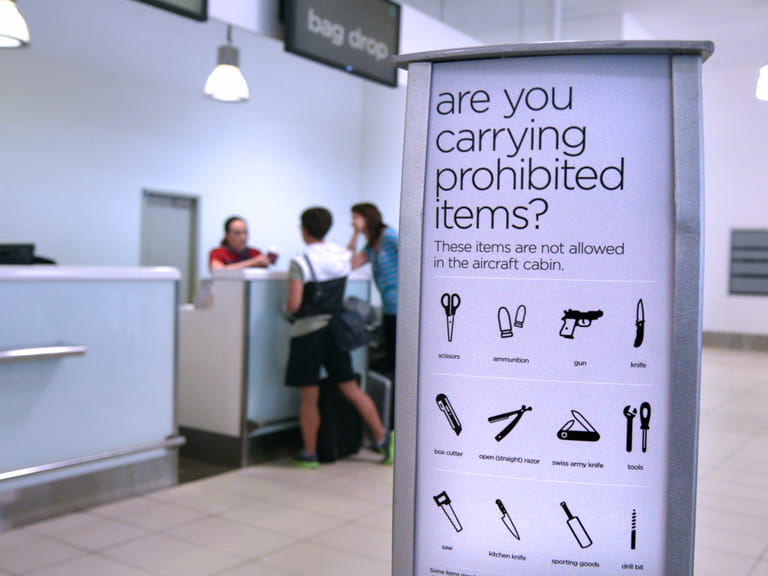 Advice board at an airport showing restricted items