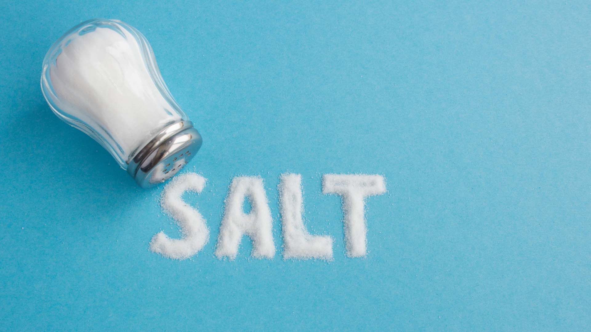 a salt cellar on its side with the word salt written out in salt on a blue background