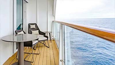 Balcony on a cruise ship with a table and two chairs