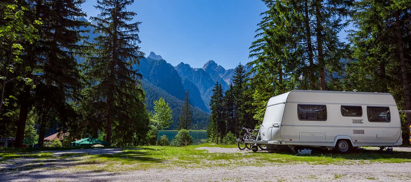 A caravan in a beautiful Italian campsite on a hot day