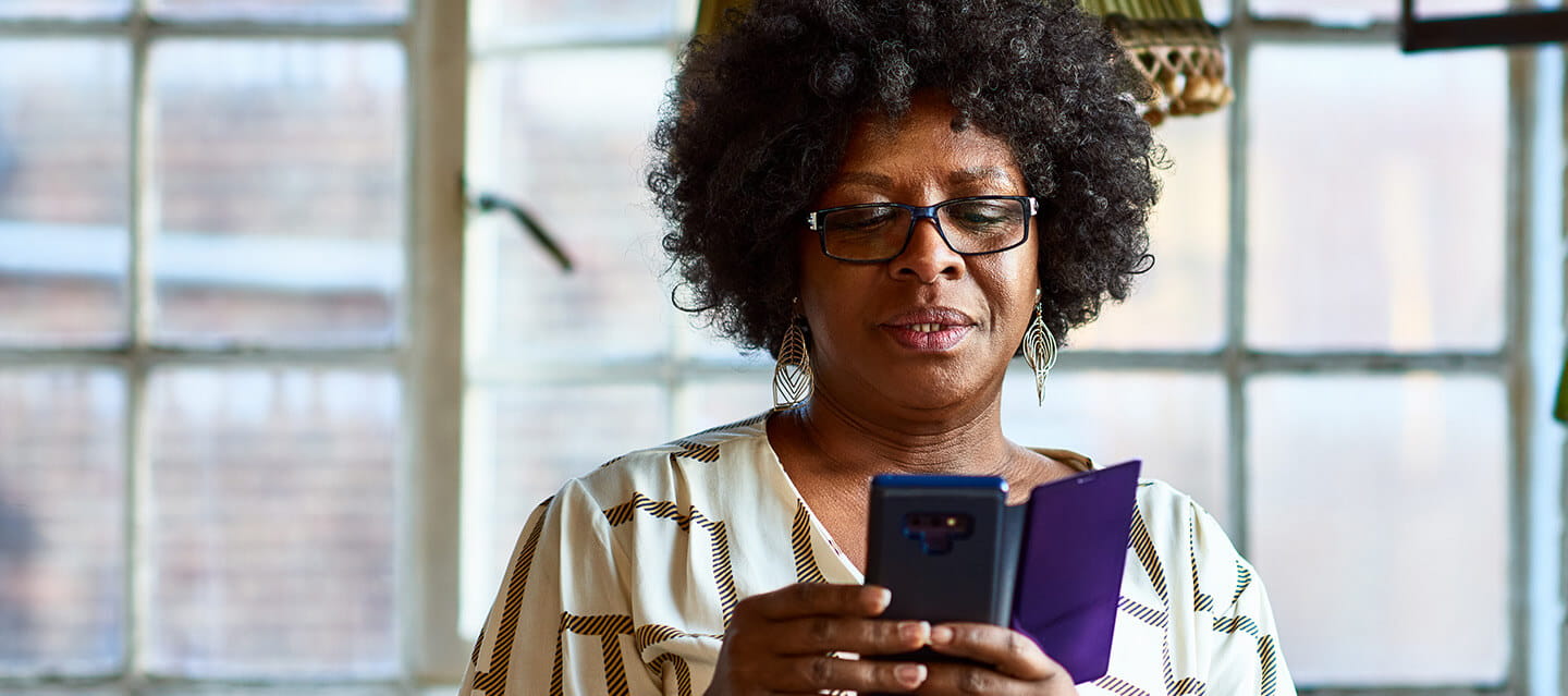 Portrait of mature woman using smartphone at home