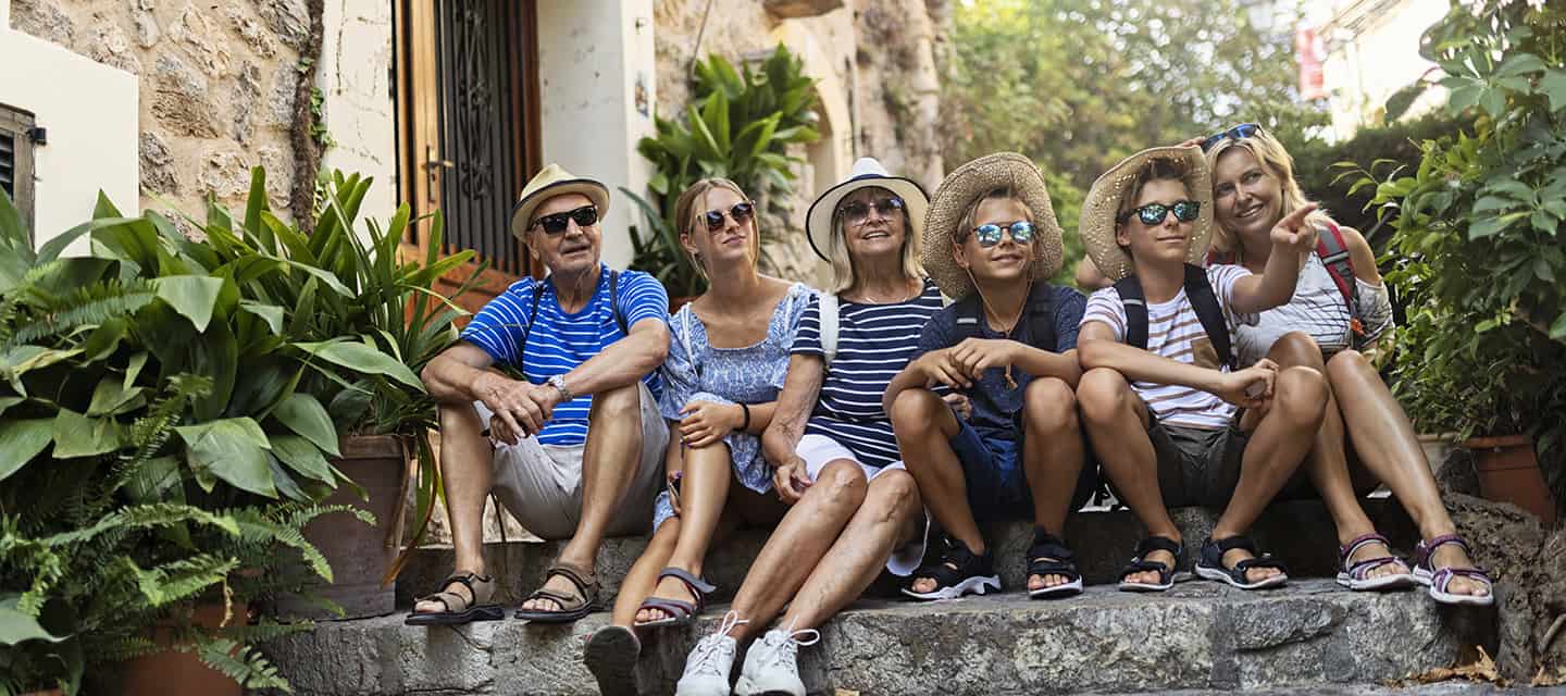 Multi generation family sightseeing beautiful town of Valldemossa, Majorca, Spain