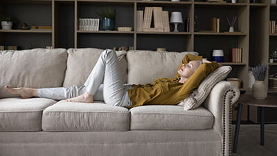 A mature woman relaxing on her sofa at home