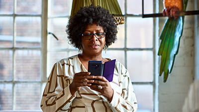 Portrait of mature woman using smartphone at home
