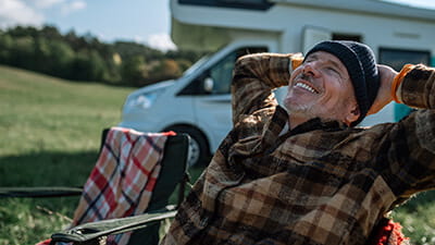 Senior man camping with his motorhome in nature.