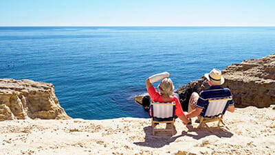 Spain, Andalusia, Cabo de Gata, back view of couple looking at the sea 