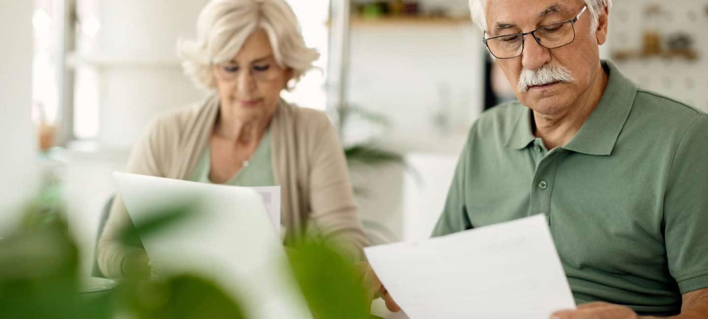 A mature couple looking through papers